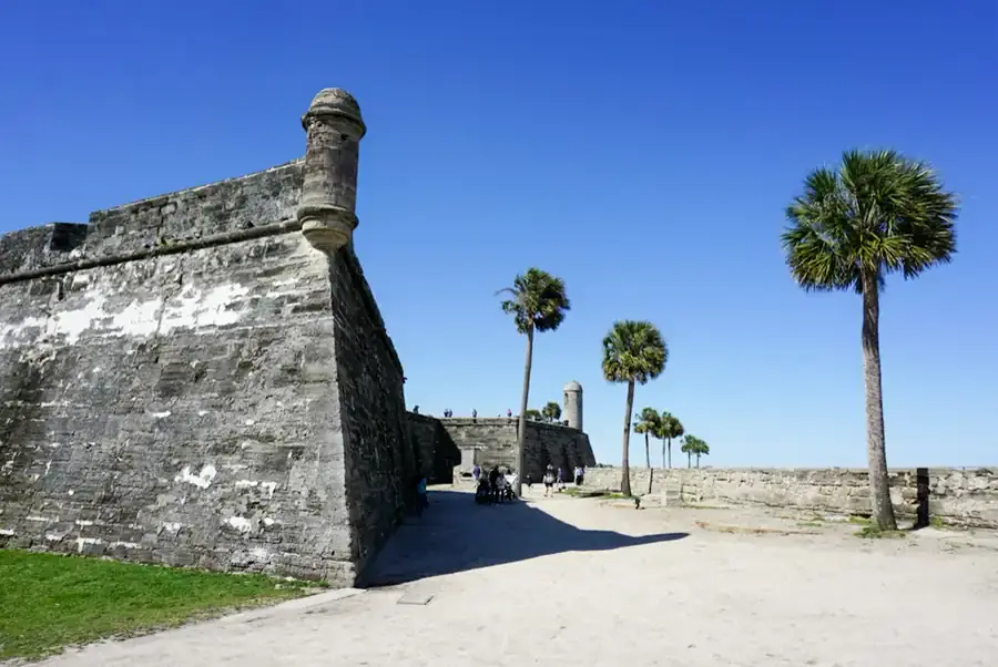 The coquina walls of the Castillo de San Marcos in St. Augustine, with palms beside them